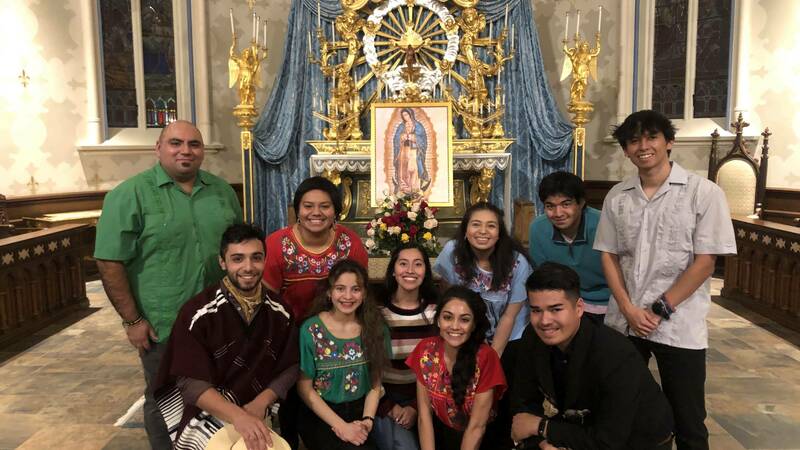 Members of Coro Primavera pose in front of the altar in the Basilica of the Sacred Heart